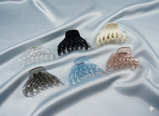Set of six hair clamps in various colors on a light fabric background