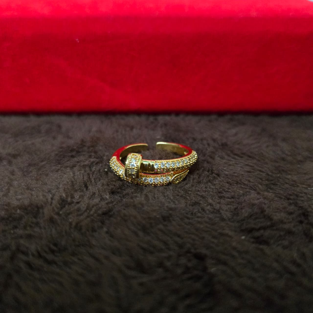 Gold ring with red interior on a dark surface