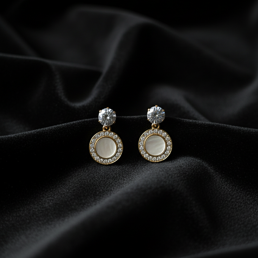 Pair of earrings on a black fabric background