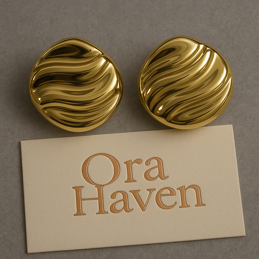 Sunset Flow gold wave earrings with elegant wavy design on a premium marble background – Ora Haven Jewelry