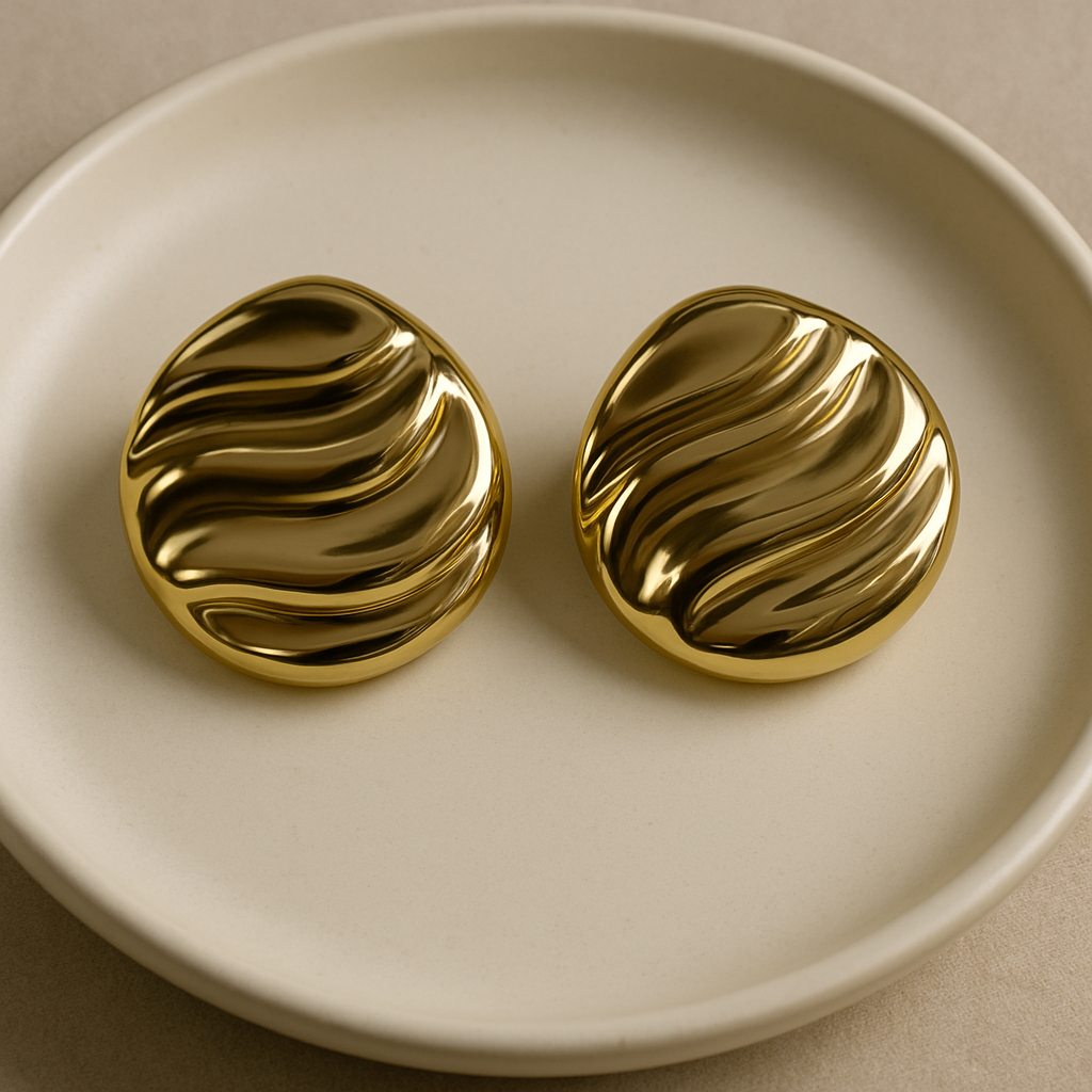 Sunset Flow gold wave earrings with elegant wavy design on a premium marble background – Ora Haven Jewelry