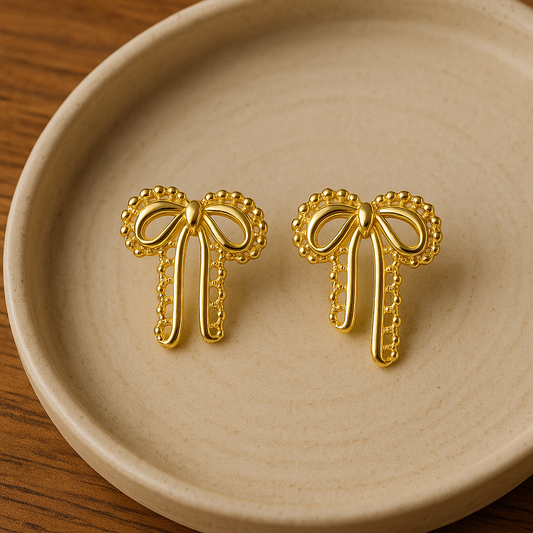 Velour Knot Earrings – elegant gold bow-shaped imitation earrings by Ora Haven, premium lightweight jewelry for everyday and festive styling.