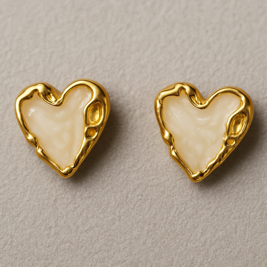 Pair of heart-shaped stud earrings with glossy Ivory enamel centers and textured gold-toned edges