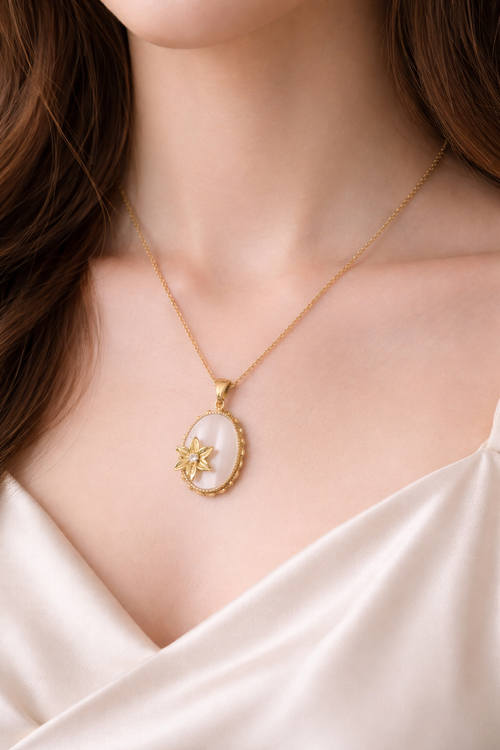 Gold necklace with a pendant around a woman's neck.