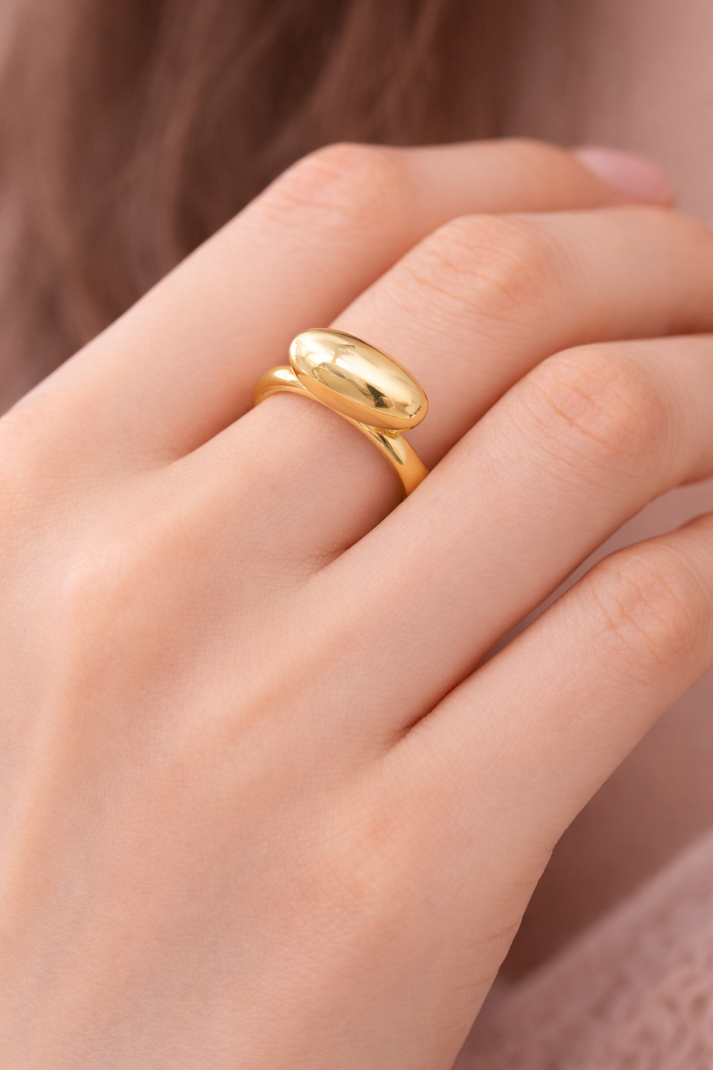 Golden Adjustable Ring on a woman's finger.