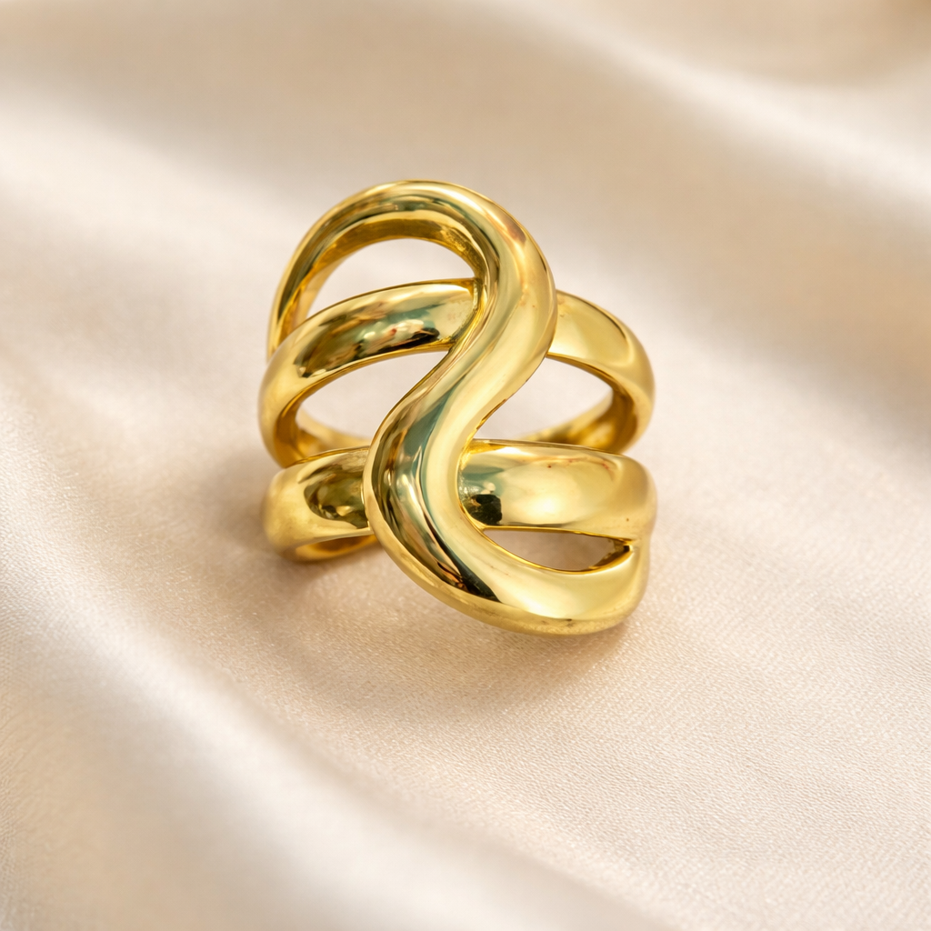 smooth swirl golden ring on a white cloth background.