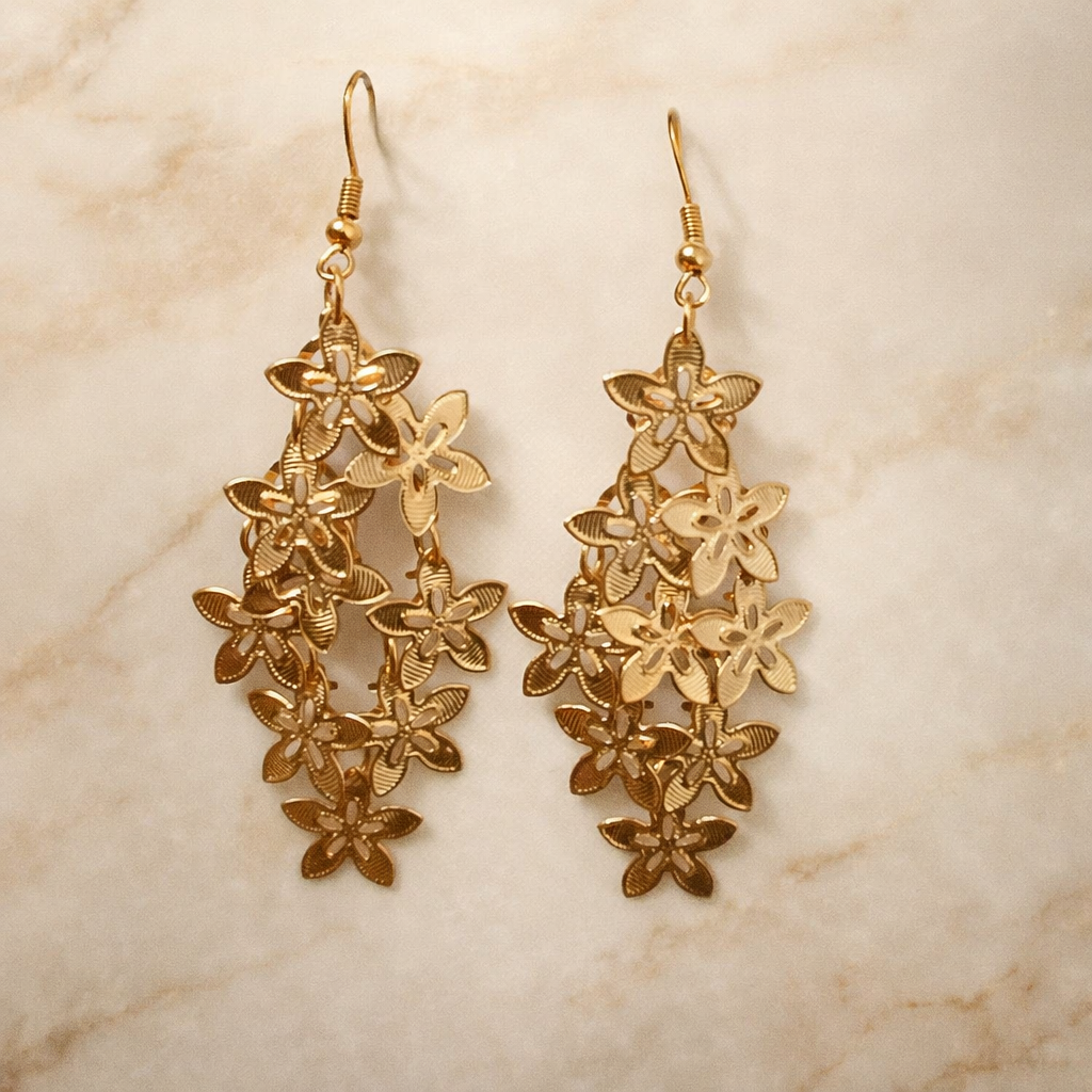 The golden earings on a light marble background 