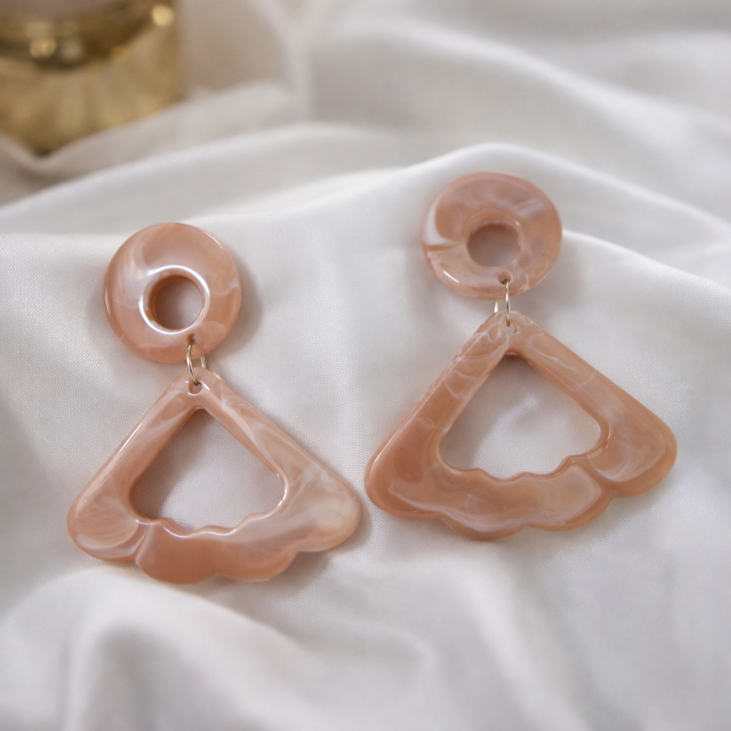 The earrings on a white cloth background 