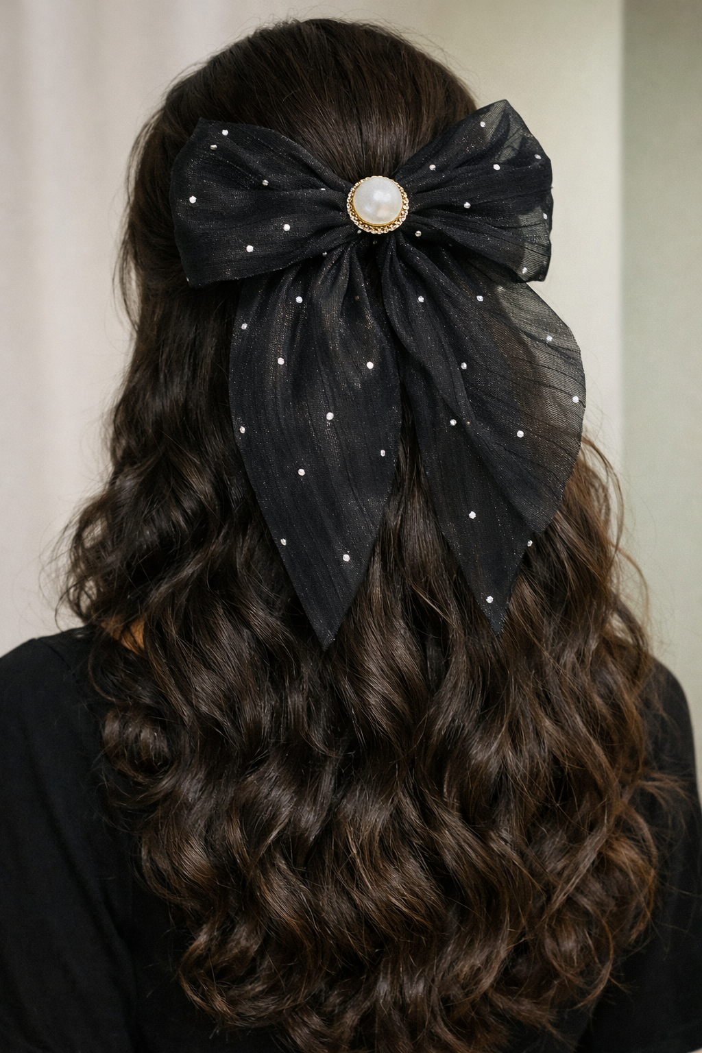 A woman wearing the black sheer bow 