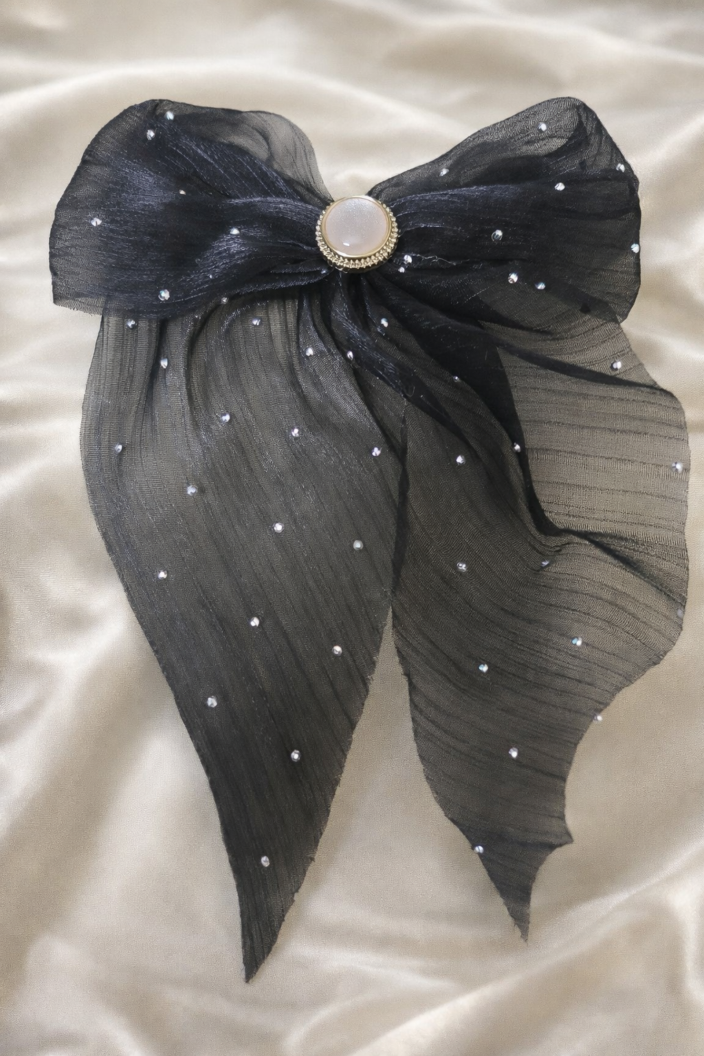 The sheer bow on a white satin cloth background 
