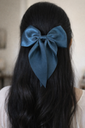 a woman wearing the teal bow 