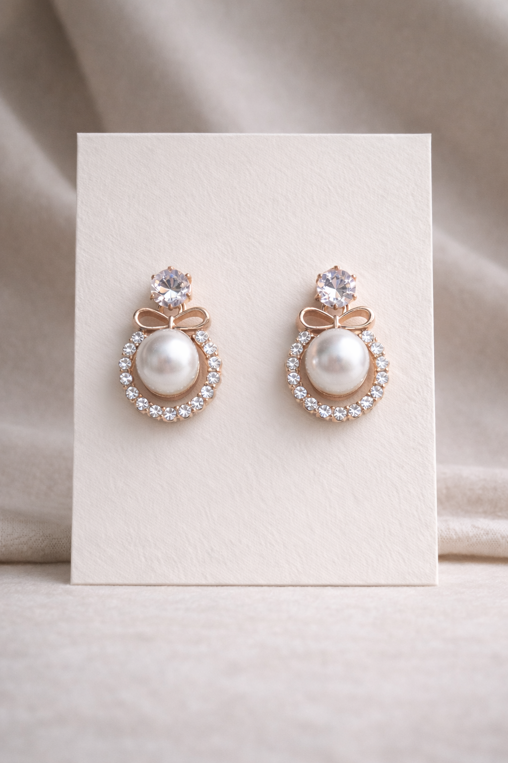 White pearl earings on a white background 