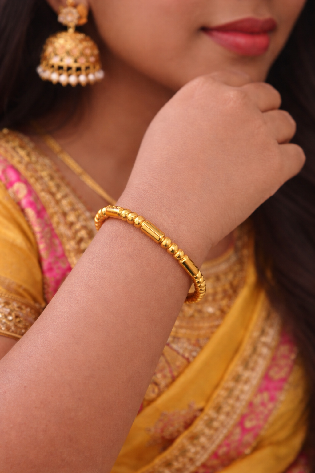 A woman wearing the golden bracelet 