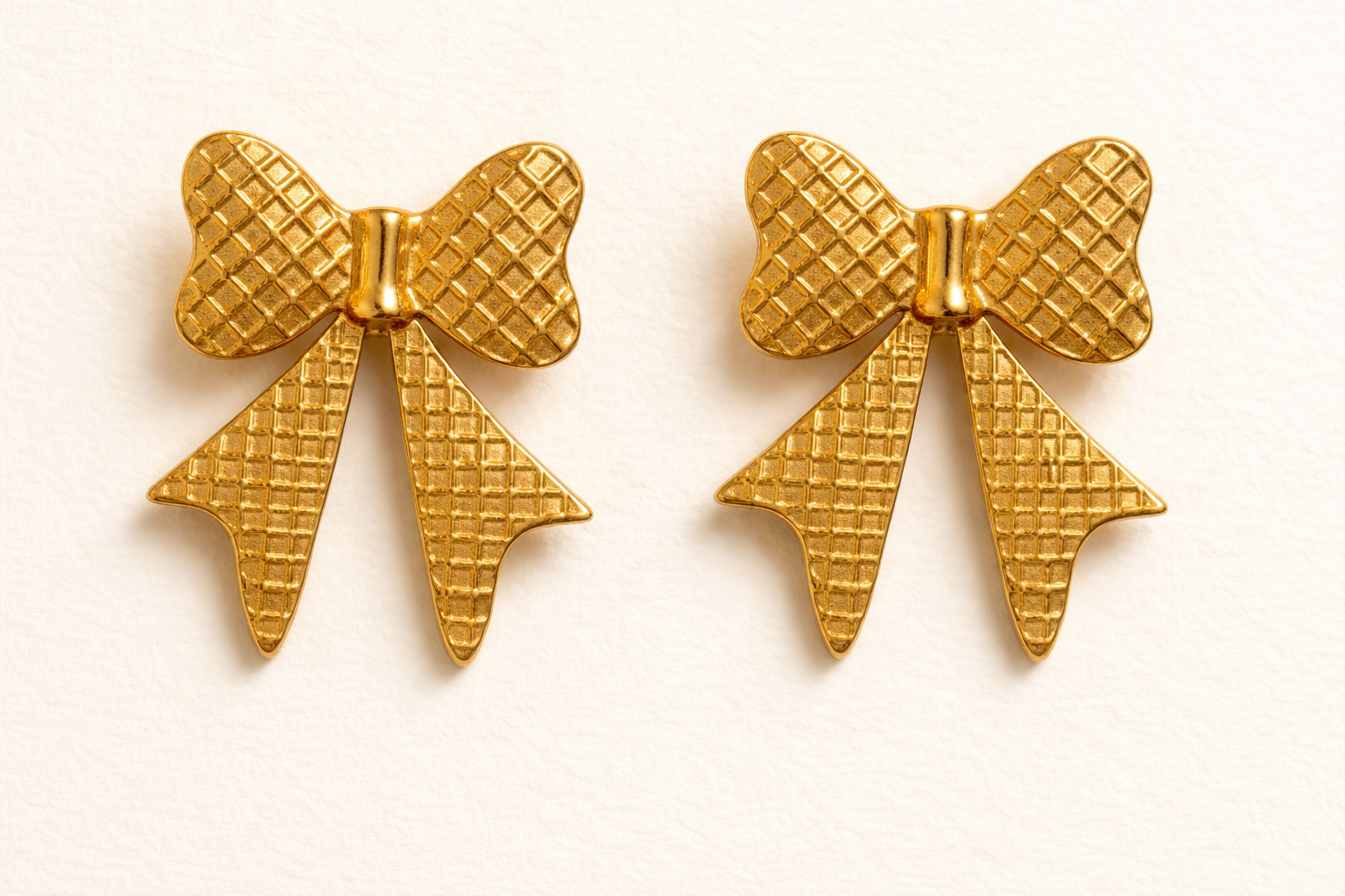 Bold gold bow-shaped statement earrings with waffle-textured finish, vintage-style geometric earrings for women
