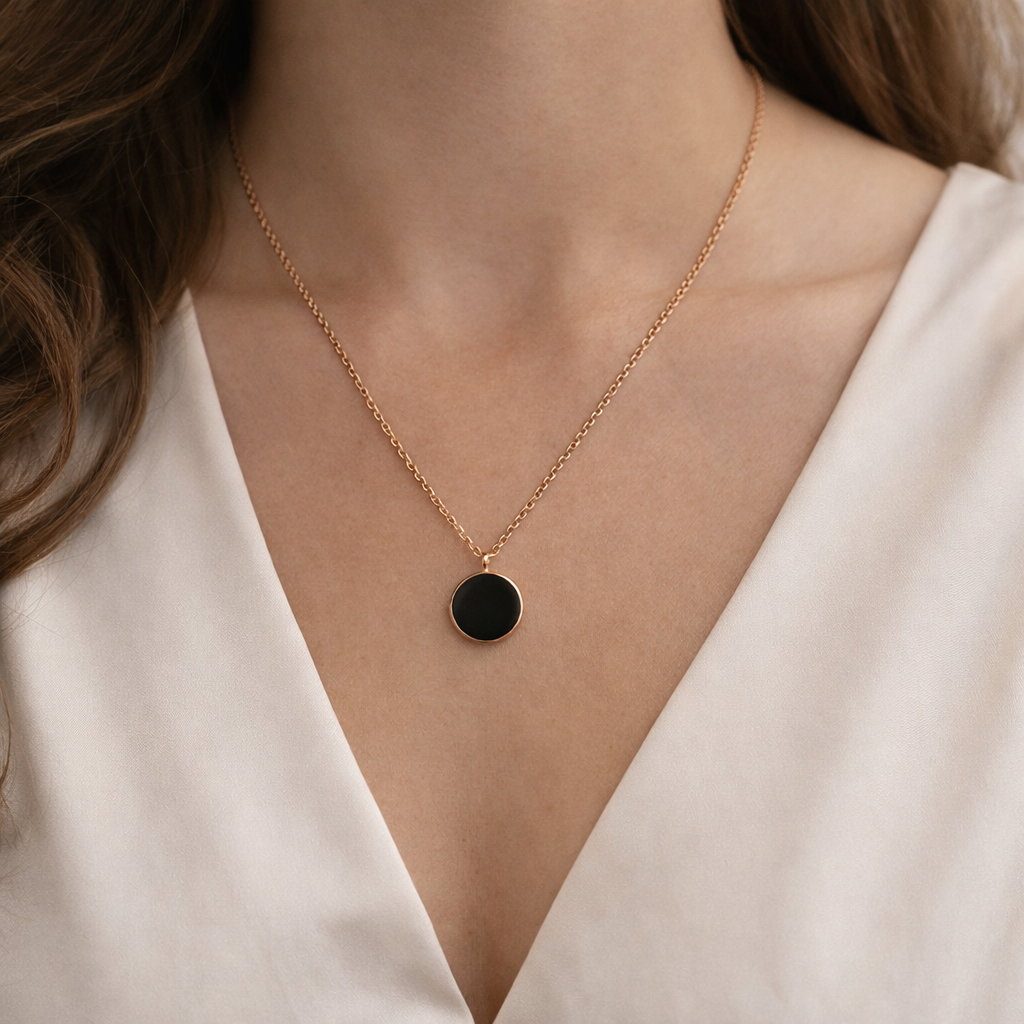 The pendant around a woman's neck.