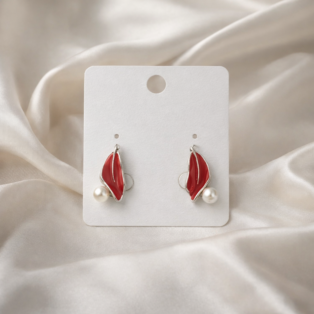 The earrings on a white cloth background 