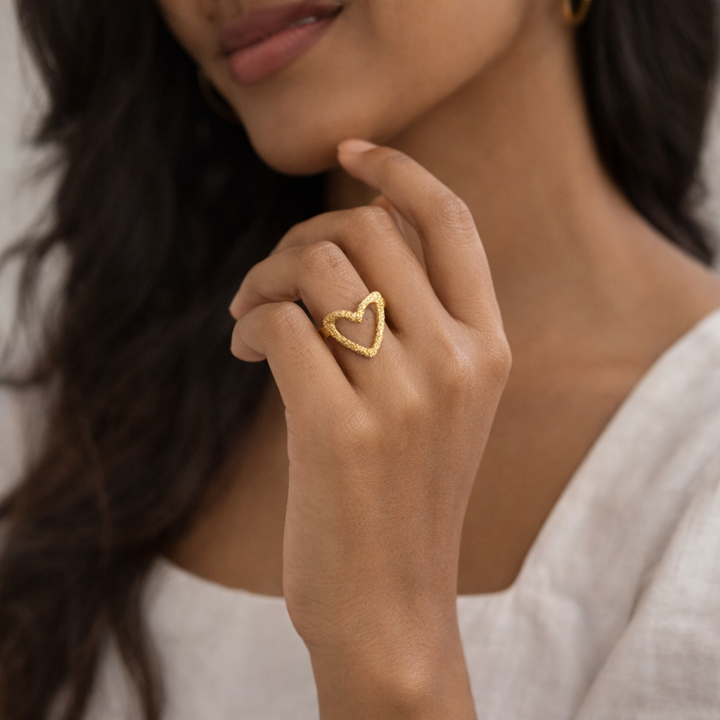 Gold heart-shaped ring on a woman's                    fingers.