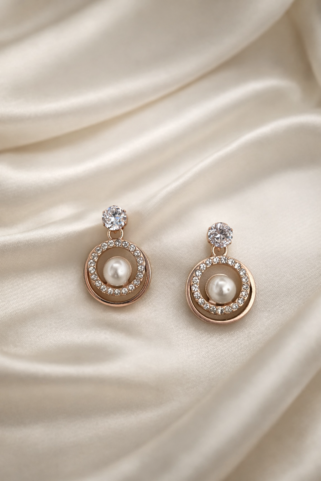 The earings on a white cloth background 