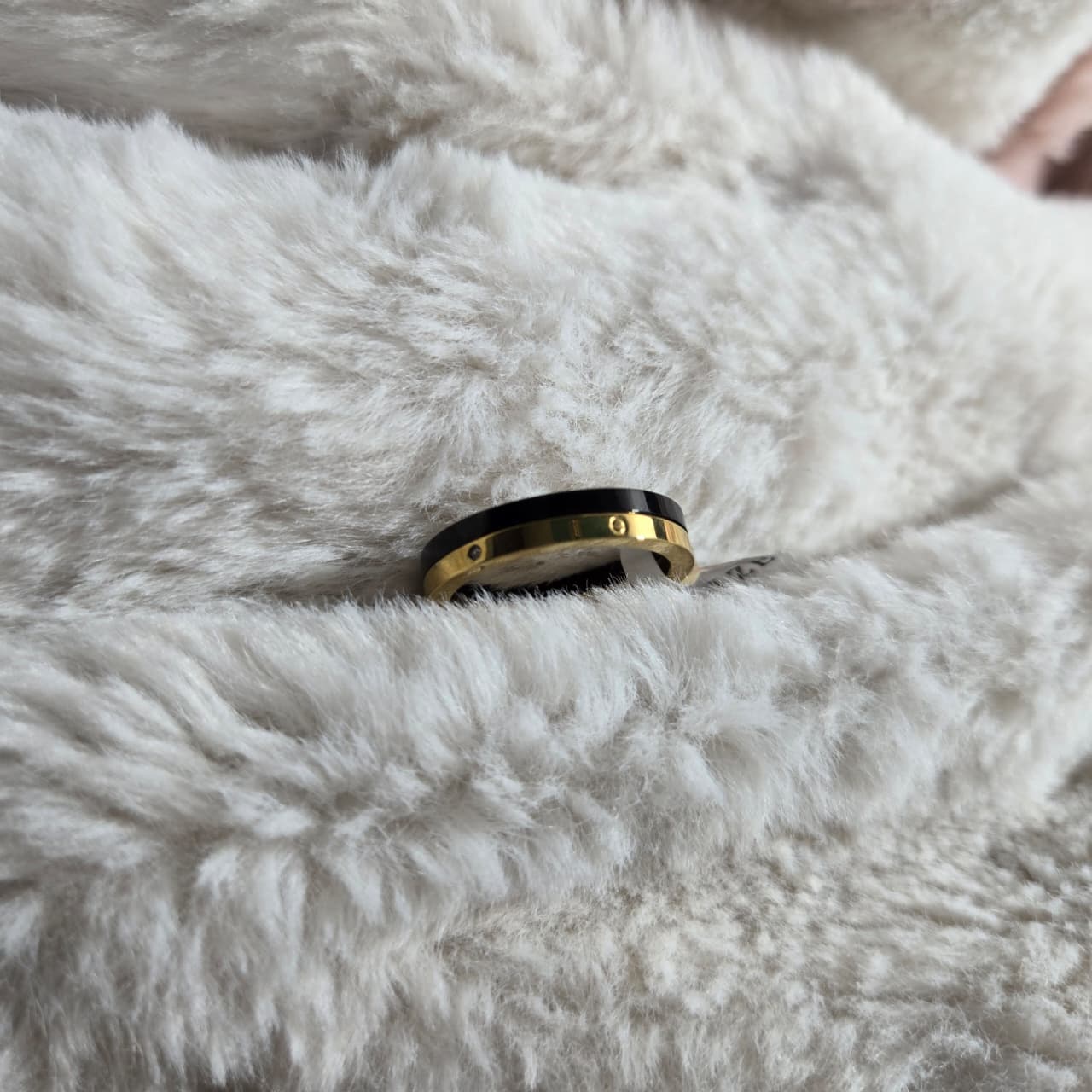 Gold ring on a fluffy white surface