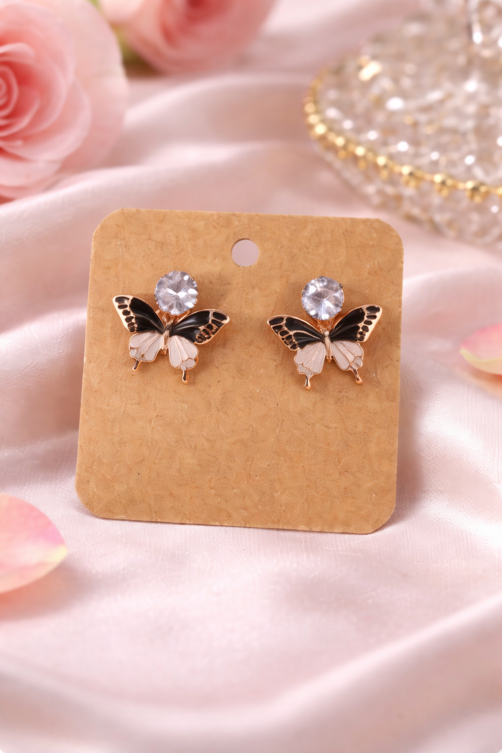 The earrings on a pink cloth background 