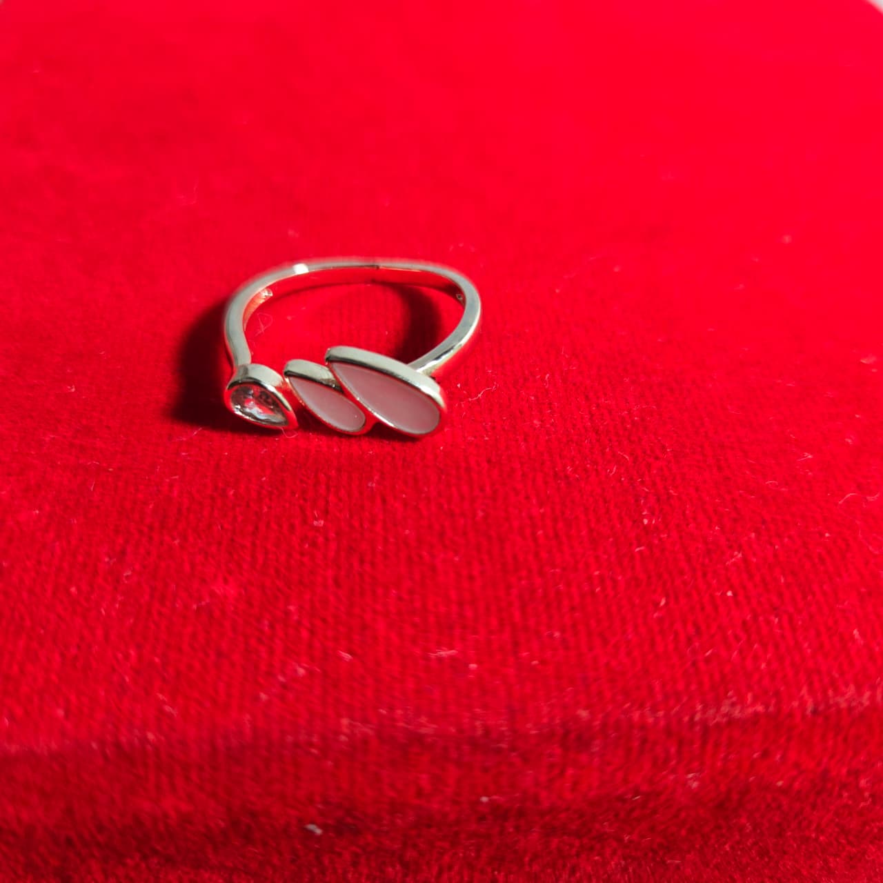 Silver ring on a red fabric background