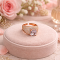Ring with a prominent gemstone on a pink circle.