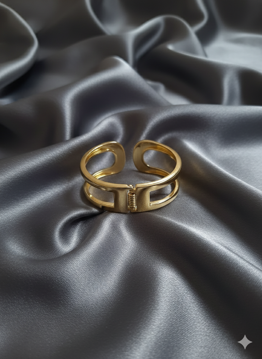 Gold ring on a gray satin fabric background