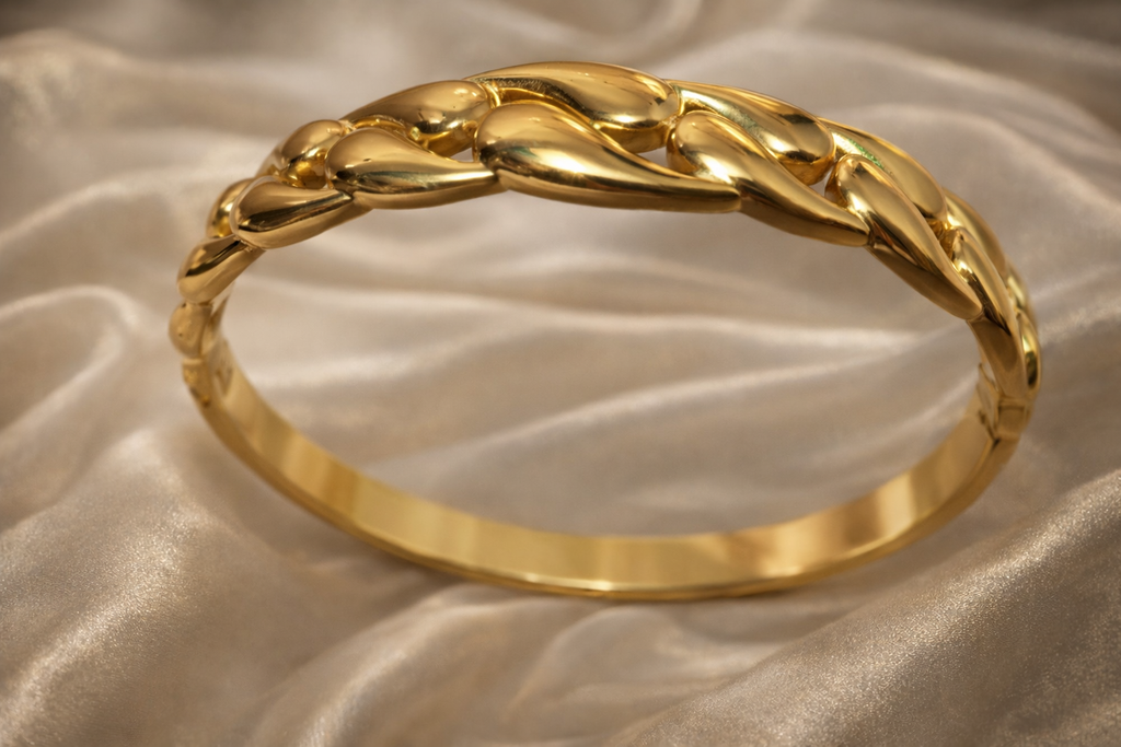 Gold bracelet on a rose cloth.