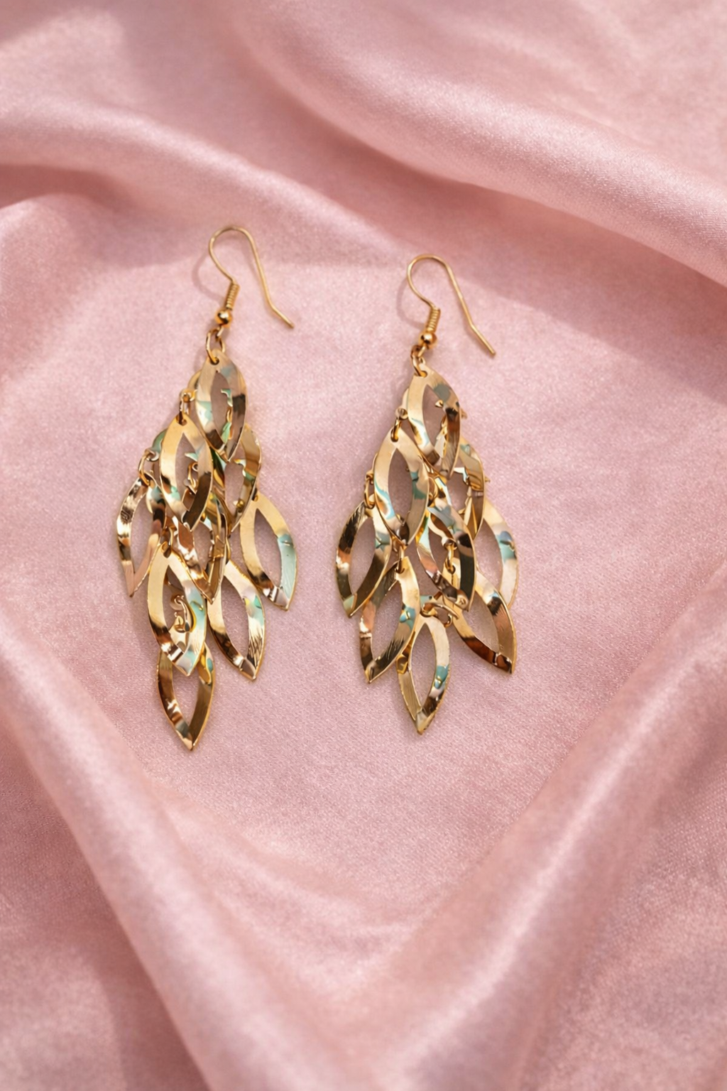 The earings on a pink cloth background 