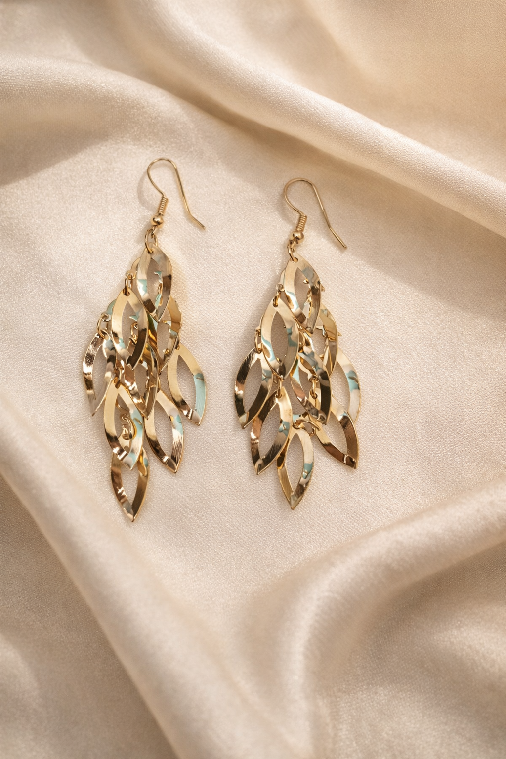 The earings on a champagne cloth background 