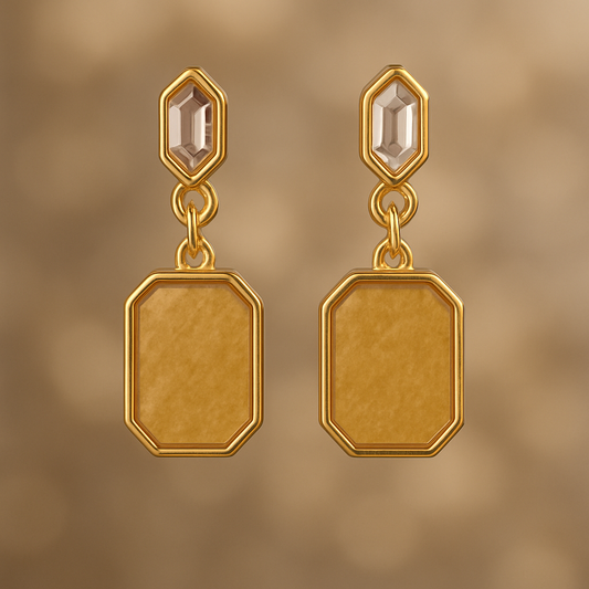 Pair of gold earrings with a geometric design on a gold background