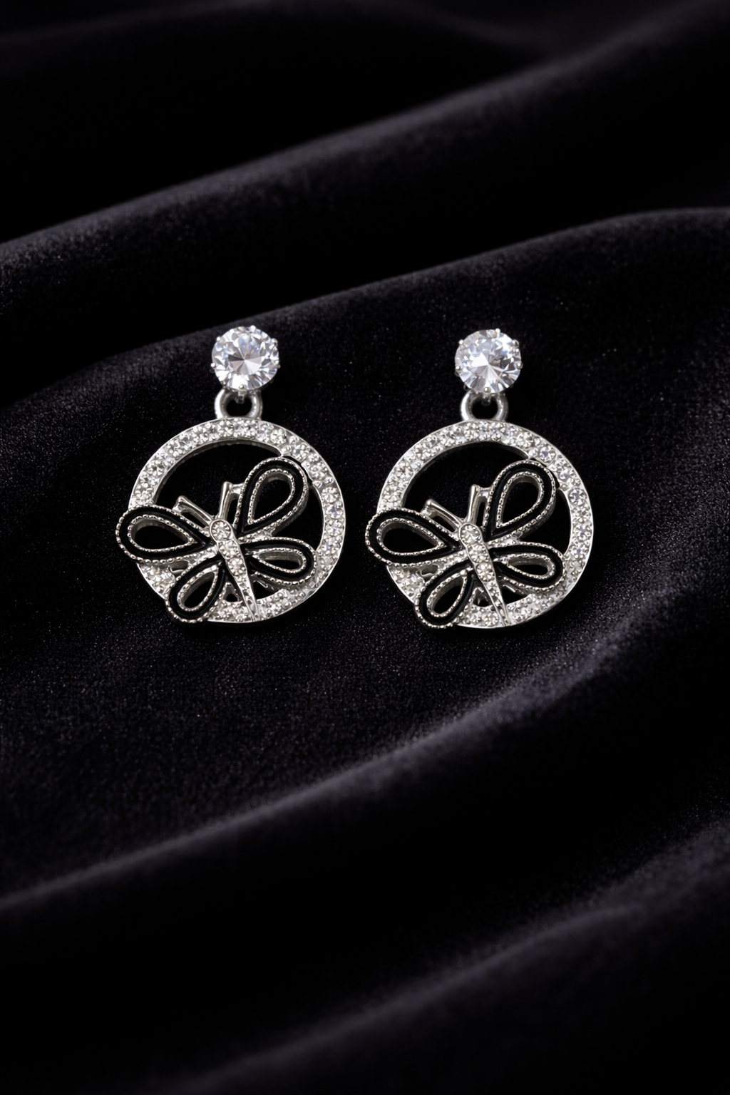 The earrings on a black cloth background 