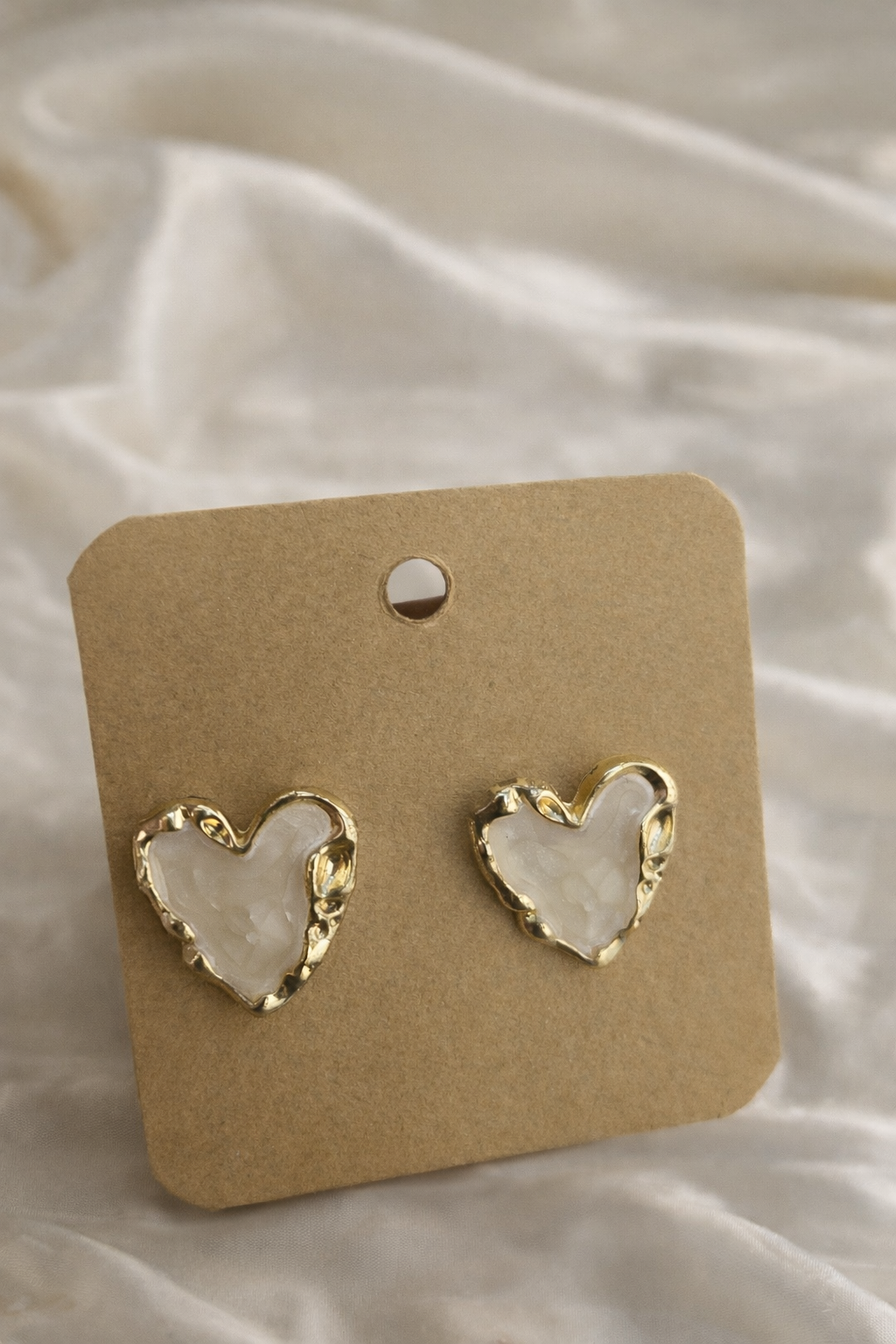 Earings on a white cloth background 