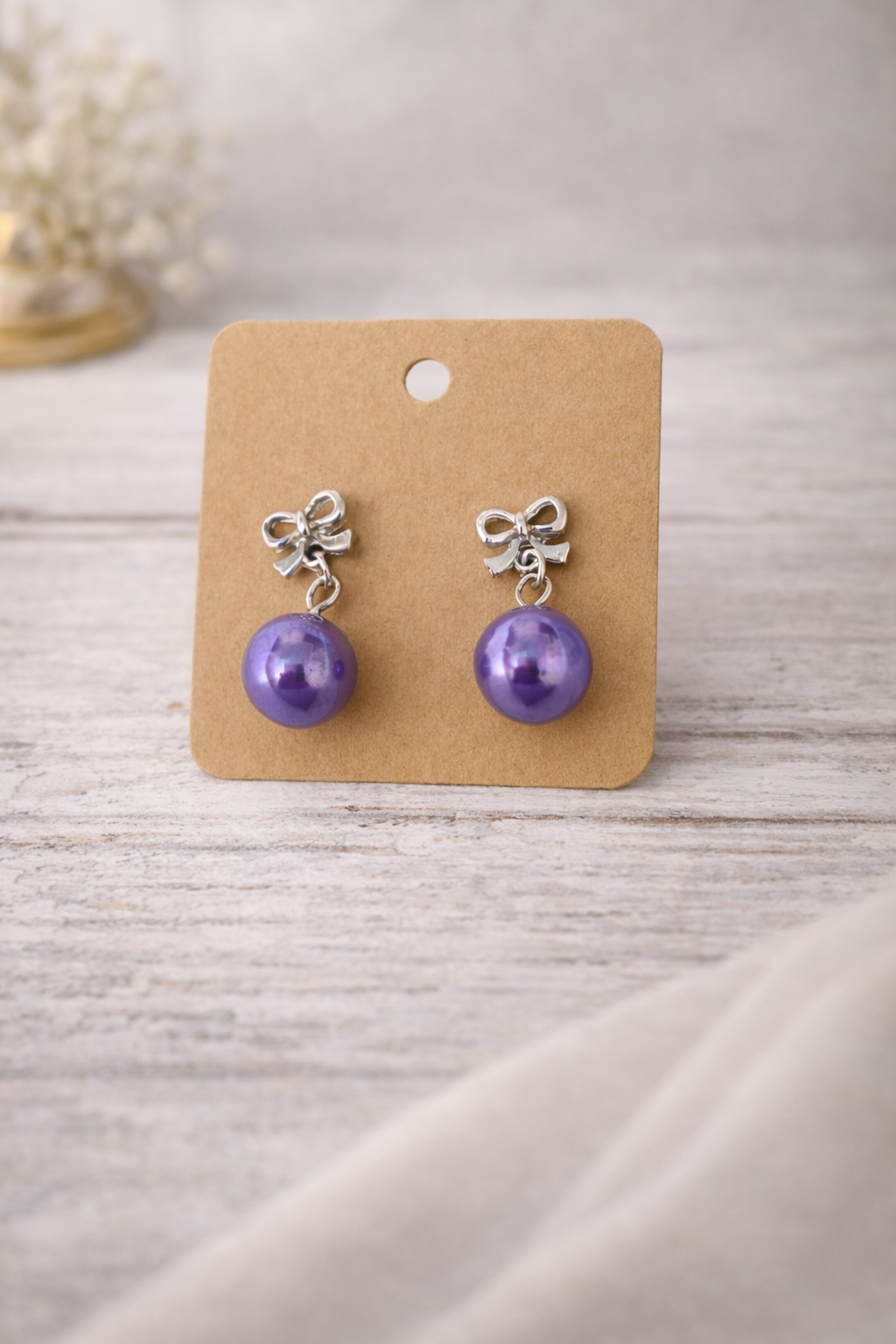 The earrings on a wood background 