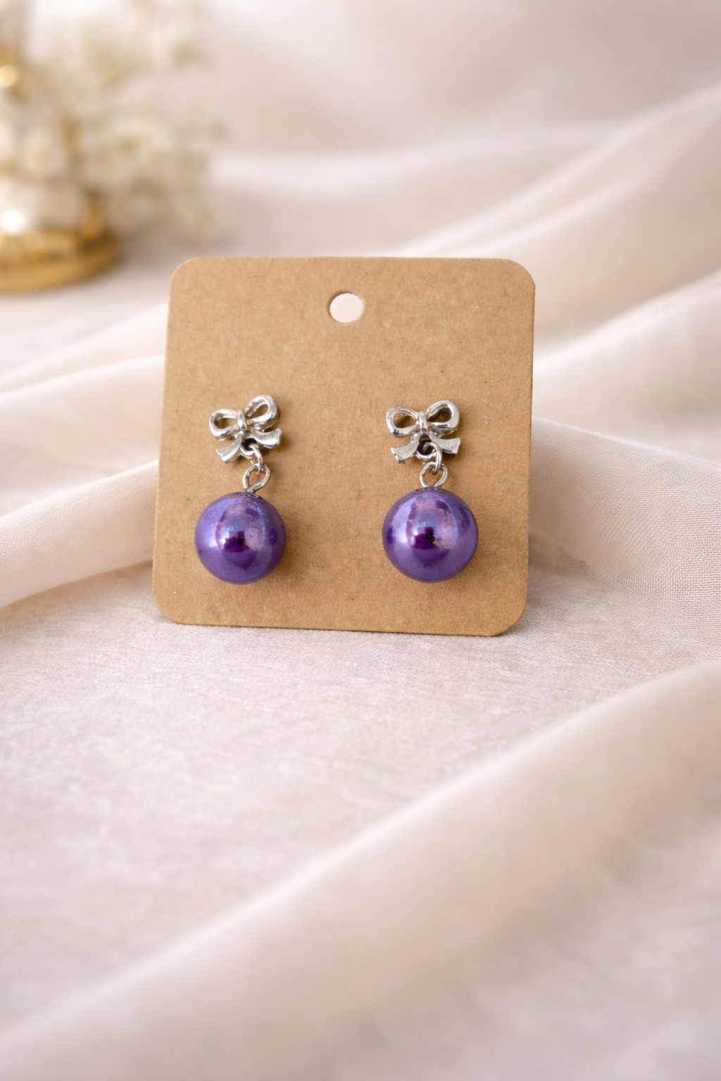 The earrings on a white cloth background 