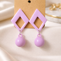 The earrings on a white cloth background 