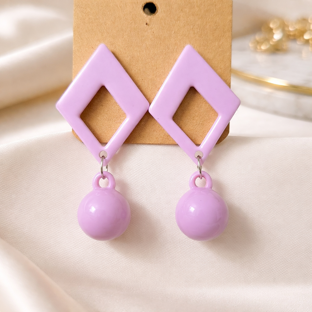 The earrings on a white cloth background 