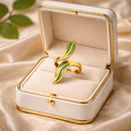 The ring in a jewelry box on a champagne cloth background 