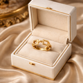 The ring in a jewelry box on a rose cloth background 