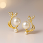 Gold earrings with pearls and crystals on a beige background