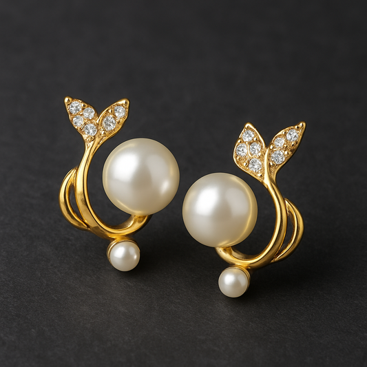 Pair of gold earrings with pearls on a dark background