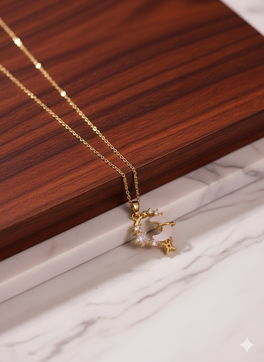 Gold necklace with a star-shaped pendant on a wooden surface