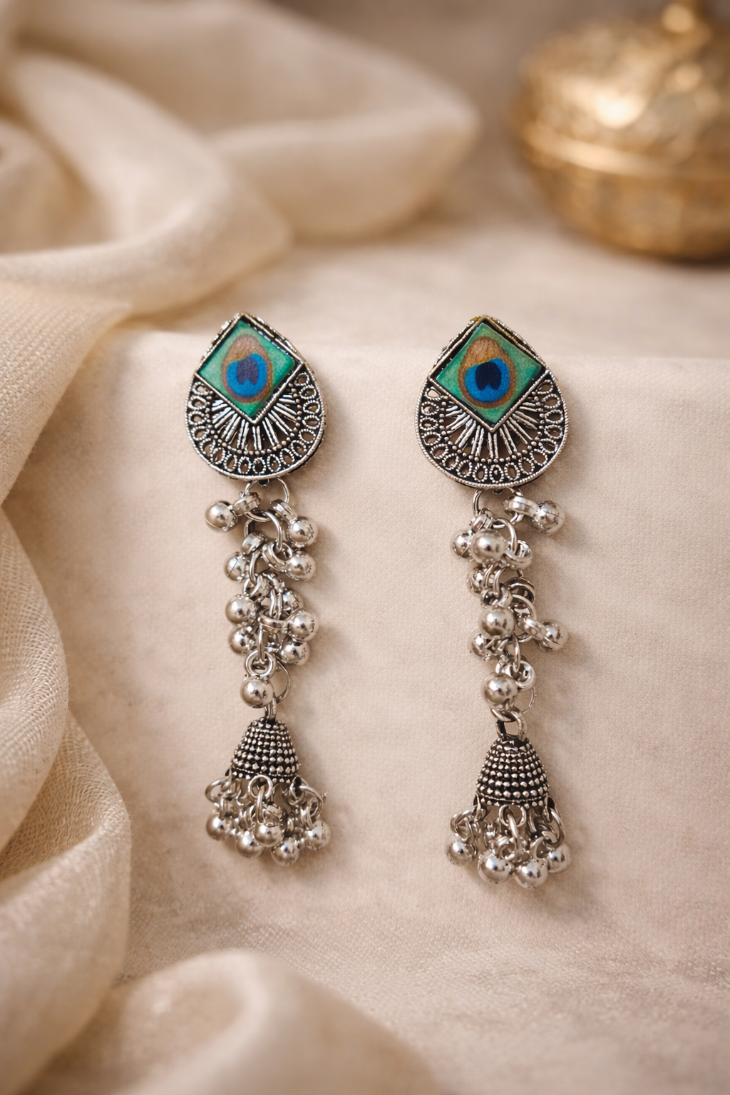 The earrings on a white cloth background 