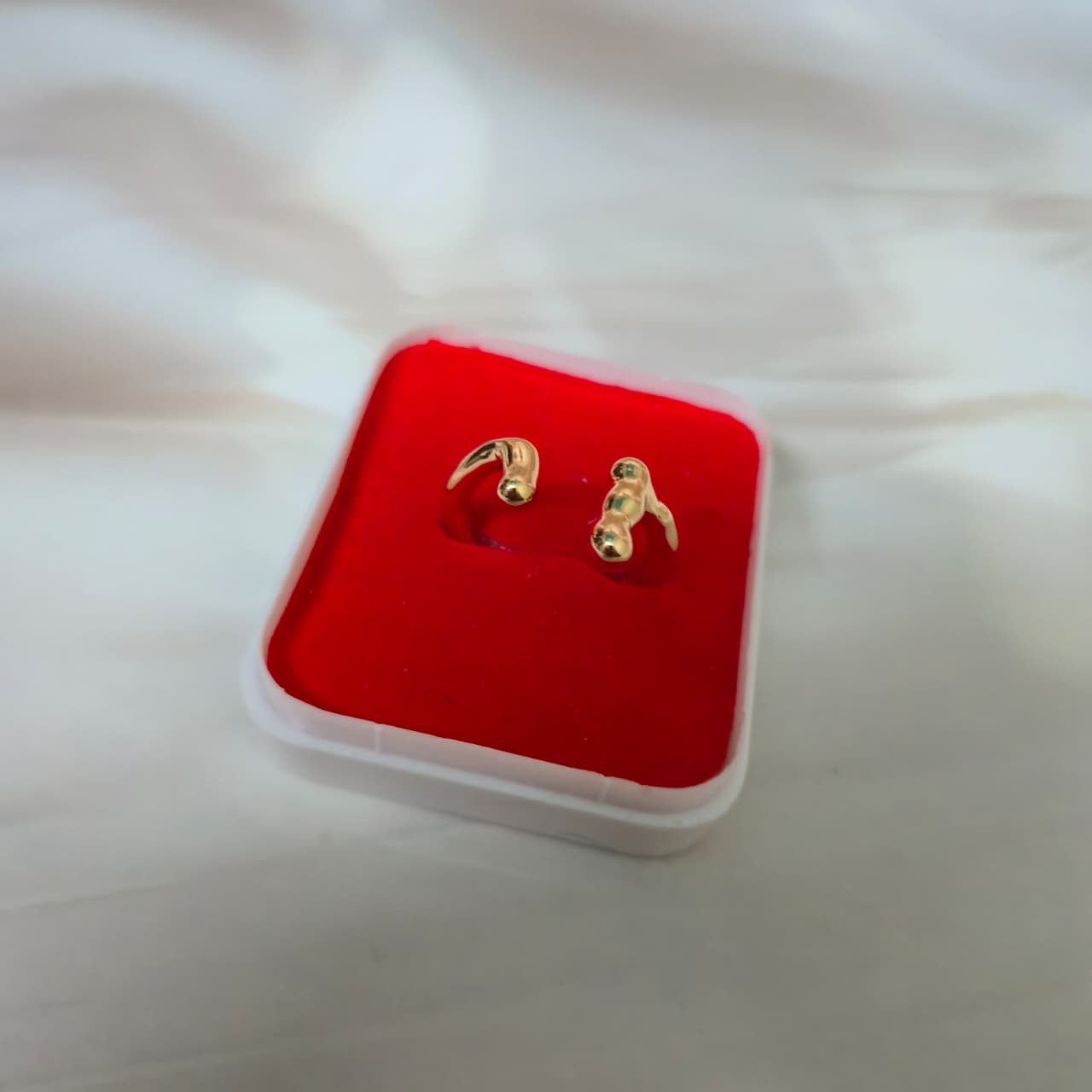 Minimal adjustable gold ring with smooth curved ends and anti-tarnish coating.