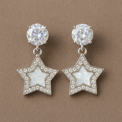 Star-shaped drop earrings with a mother-of-pearl center, surrounded by sparkling crystals, and topped with dazzling round studs for a glamorous finish