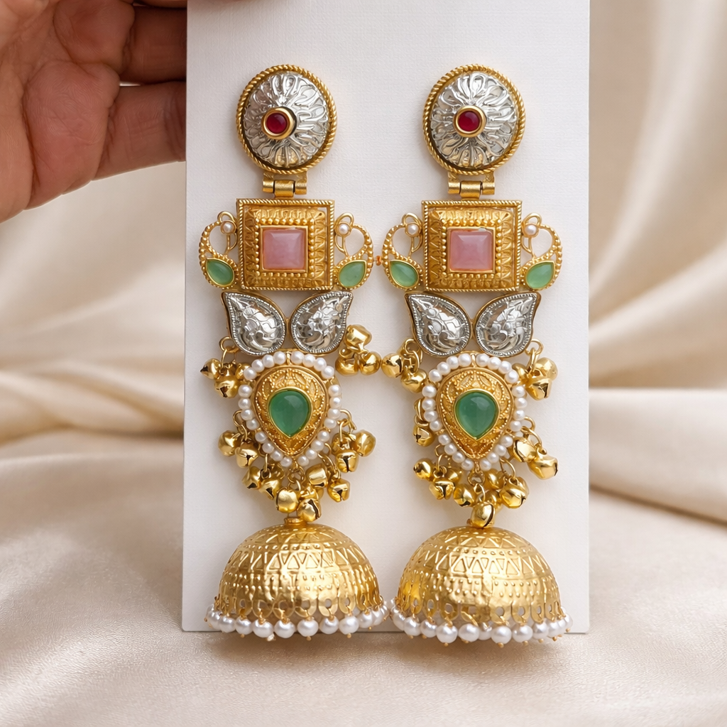 The earrings on a rose cloth background 