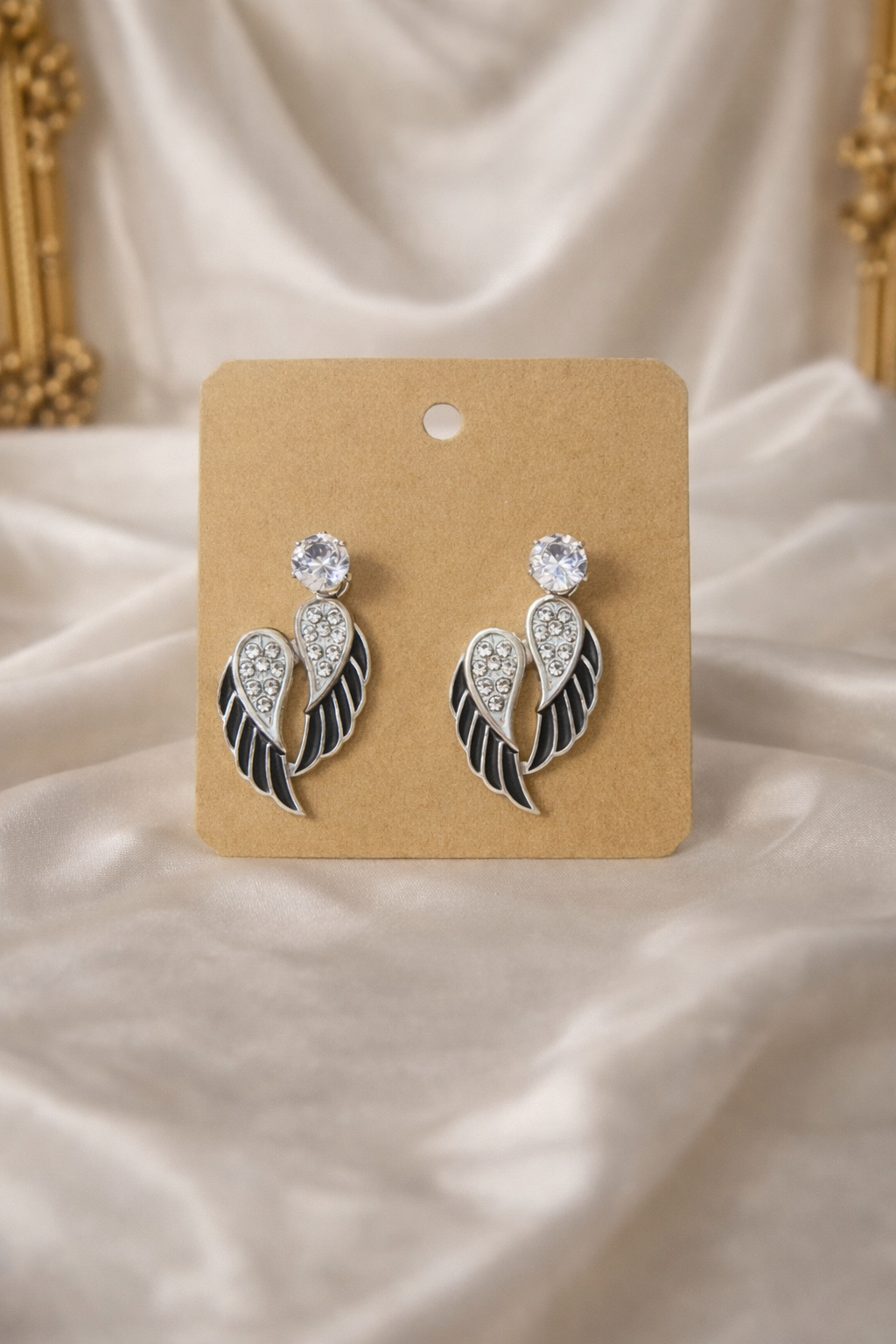 The earrings on a white cloth background 