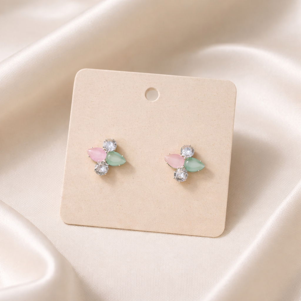 The earrings on a rose cloth background 