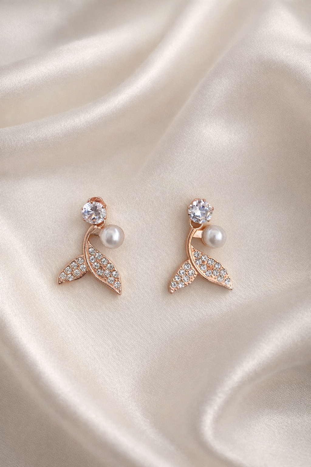 The earings on a gray cloth background 