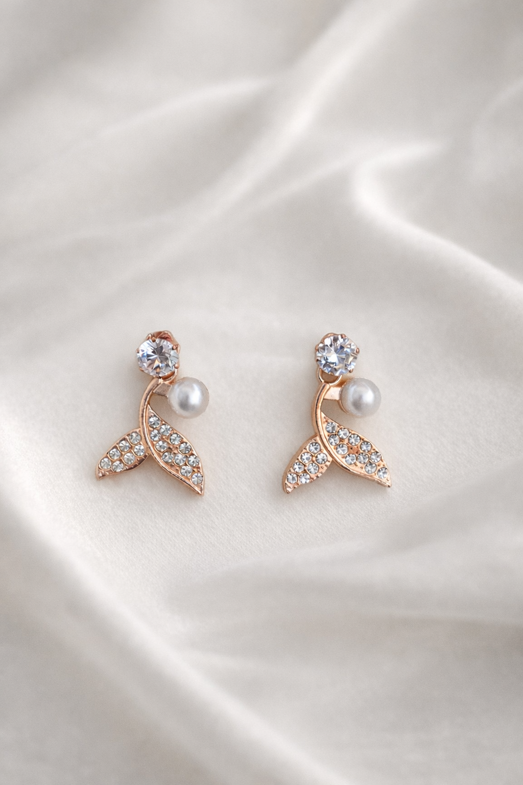 The earings on a white cloth background 